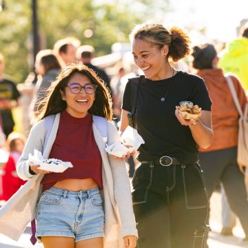 Students laugh and enjoy food at the annual UWEC Meets EC event.