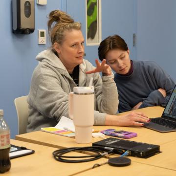stage crew meeting at Pablo, around a table with laptops 