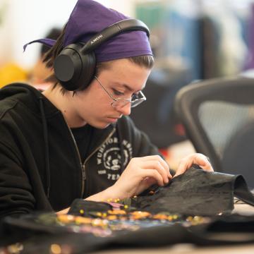 student creating a theater costume 