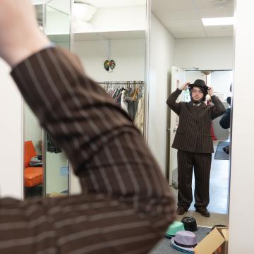 cast member looking in mirror in dressing room 