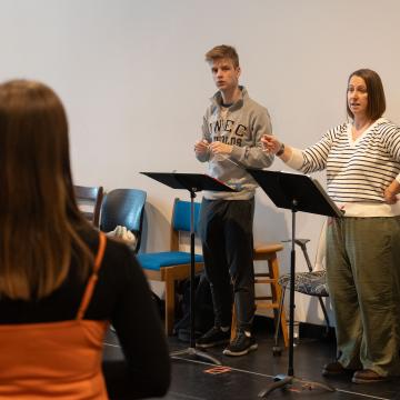 music rehearsal for Guys and Dolls, students at music stands 