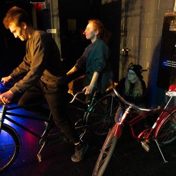 cast member waiting to head on the stage on bikes in Guys and Dolls