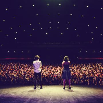 Two speakers in front of a crowd