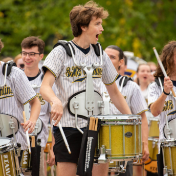 Blugold Marching Band drumline snare drummers performing outside Carson park