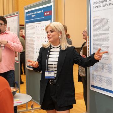 A marketing student presents her poster project at CERCA.