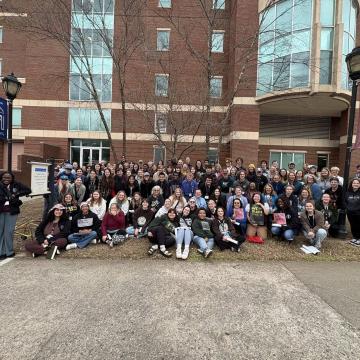 A large group of students smile at the camera during the Civil Rights Pilgrimage.