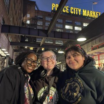 Students smile in front of the Ponce City Market.