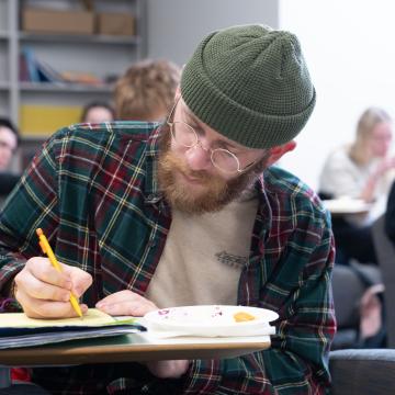 A French student writes in his notebook during class.