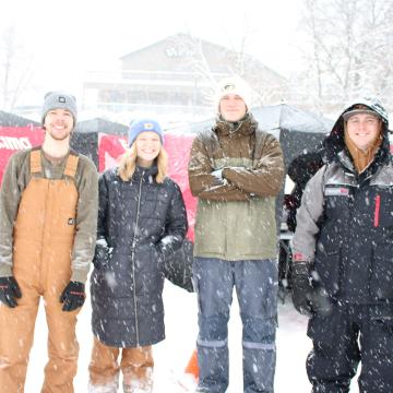 4 people in snow gear standing at the snow in the JigsUp contest