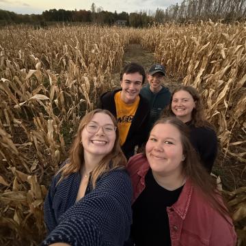 Honors students traverse a cornfield