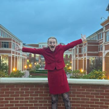 Austyn Clemen in red standing at dusk in front of UW-Madison