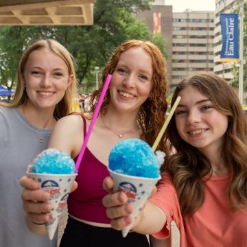 Students smile holding snow cones during Welcome Week.