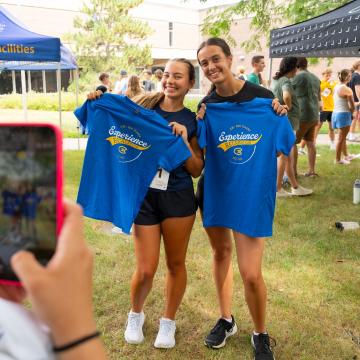 Students pose with Tshirts during Blugold Welcome Week.