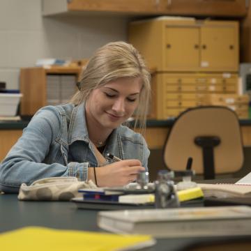 UW-Eau Claire – Barron County student takes note during science lab.