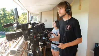 broadcast students shooting Blugold football in booth