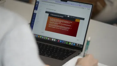 laptop open to an Economic slide