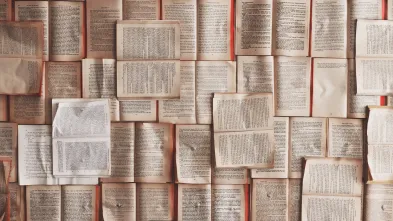 Books laying flat open in a pile