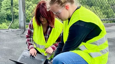 students testing for ENPH issues on a roof top 