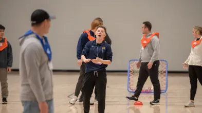 A student leads an activity during a physical education conference at the Sonnentag