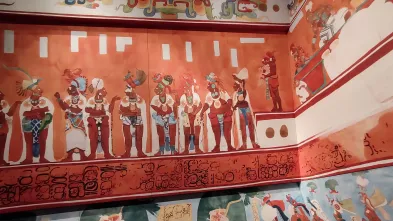 A colorful mural portraying a group of people from Latin America.