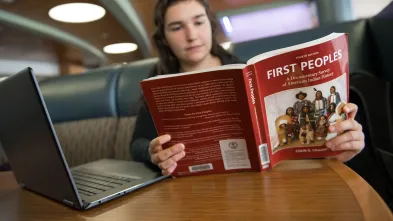 Student reading a textbook