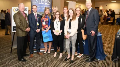 A group of people gather for a photo at the 2022 CHAASE Health Care Administration Annual Banquet
