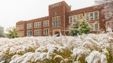 Schofield Hall with frost-covered grasses in the foreground.