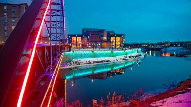 Pablo Center at sunset with colorful lights lighting up the bridge and river