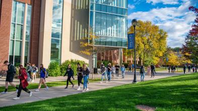 Students passing between classes sunny fall day near Centennial Hall 