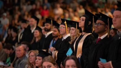 Graduates stand ready to receive their diploma 