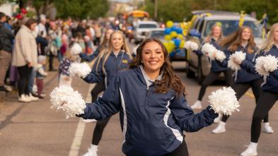 A UWEC cheerleader performing during a homecoming parade