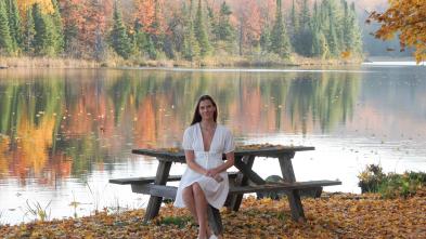 Student at a bench in front of a lake