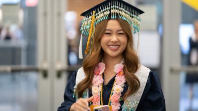Student in cap and gown, cap decorated with Hmong beading 