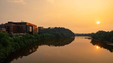 A view of the sun setting on the Chippewa River. The Riverside Science Center is in the background.
