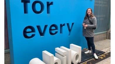 UW-Eau Claire student Kristina Tlusty stands in front of UNICEF sign