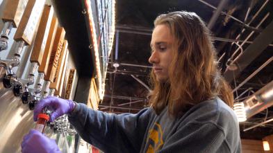 male student tapping beer in a local brewery