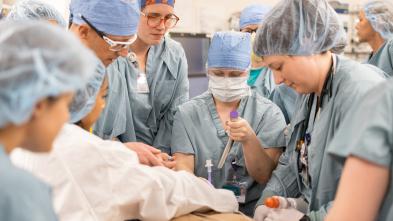 group of medical providers in full scrubs, simulation of code blue
