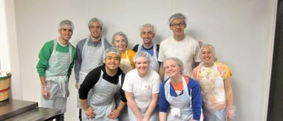 People wearing protective wear to serve a meal
