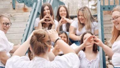 Members of a sorority making hand symbols that represent their organization