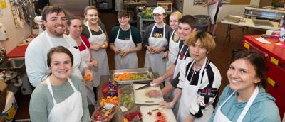 Students preparing a meal at Community Table