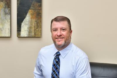 Jason Plante sitting at a desk 
