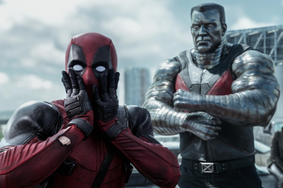 Deadpool with their hands on their mask looking shocked.