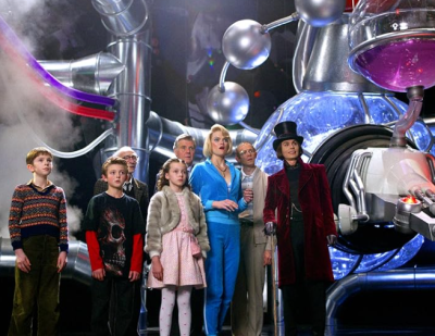 Seven children and guardians touring Wonka's chocolate factory.