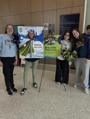UW-Eau Claire gymnastics team poses while helping register NMDP donors during a drive in Centennial Hall.