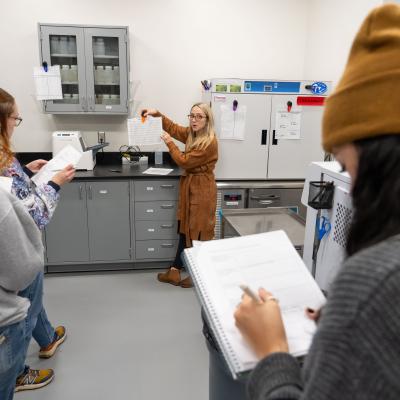 Student writes on a notepad during a lab visit for the Environmental Public Health program.