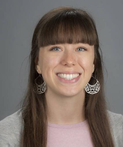 Headshot of a white woman with long brown hair.