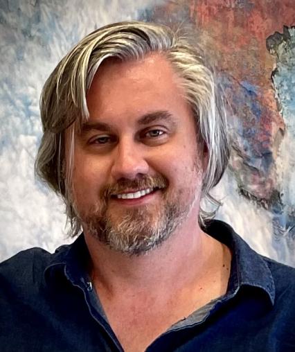 An headshot of Adam Kunz