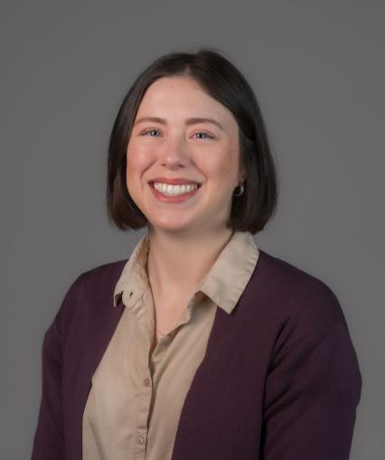 Joann headshot wearing purple cardigan and button up shirt
