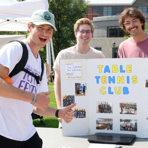 A picture of Table tennis club member at BoB presenting their trifold board
