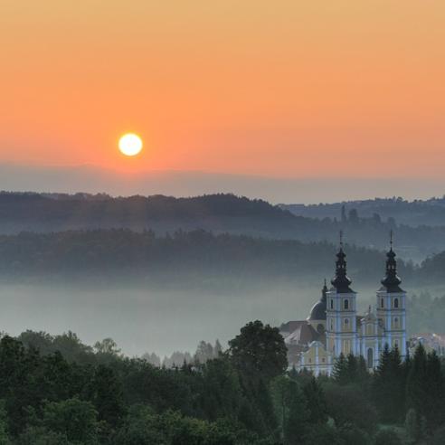 A serene sunrise scene with a baroque church 